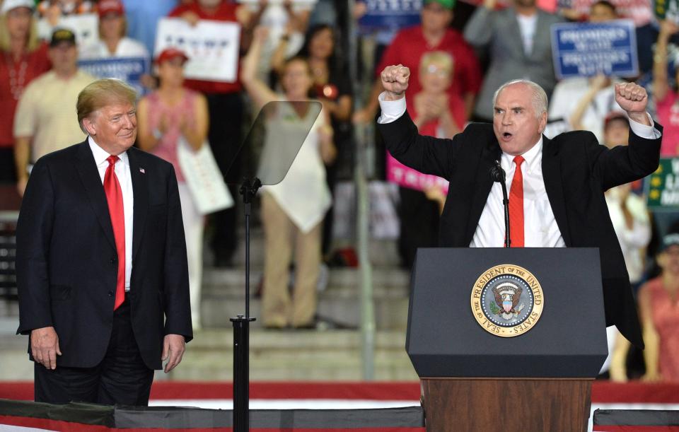 President Donald Trump, at left, watches as U.S. Rep. Mike Kelly, of Butler, R-3rd Dist., chants "USA, USA" during a rally at the Erie Insurance Arena on Oct. 10, 2018. Thousands turned out to fill the arena for the president.