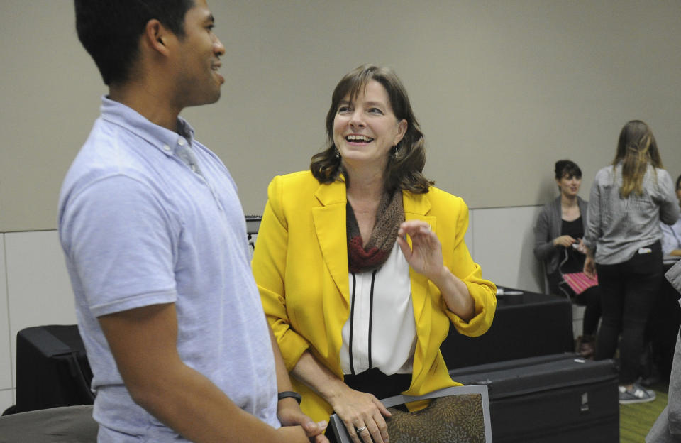 Independent candidate for U.S. Congress Alyse Galvin speaks with a supporter Tuesday, Aug. 21, 2018, in Anchorage, Alaska. Galivn hopes to face long-time congressman Don Young in the general election. (AP Photo/Michael Dinneen)