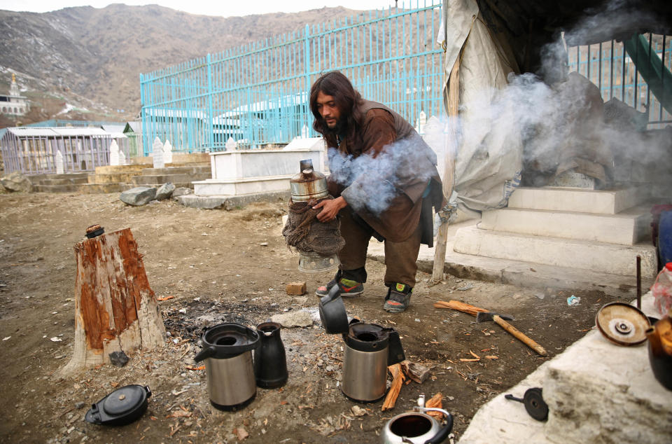 FILE - In this Jan. 13, 2014, file photo, an Afghan man prepares tea as he waits for customers in Kabul, Afghanistan. With millions of dollars in foreign aid flooding into the country, many Afghans still live in poverty. Uncertainty over how many U.S. troops might remain in Afghanistan beyond this year has trickled down to American diplomats and aid workers whose efforts over the last decade to develop the still mostly primitive country faces a drawdown of its own because of security fears. (AP Photo/Massoud Hossaini)