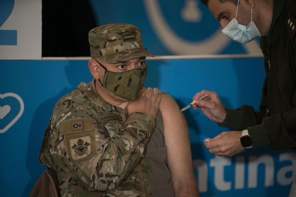 A soldier receives the AstraZeneca vaccine for the new coronavirus at a newly inaugurated vaccination site at the Nestor Kirchner Cultural Center, the largest cultural center in Latin America, in Buenos Aires, Tuesday, June 15, 2021. Argentina is speeding up its vaccination process amid a severe, second COVID-19 wave. (AP Photo/Victor R. Caivano)