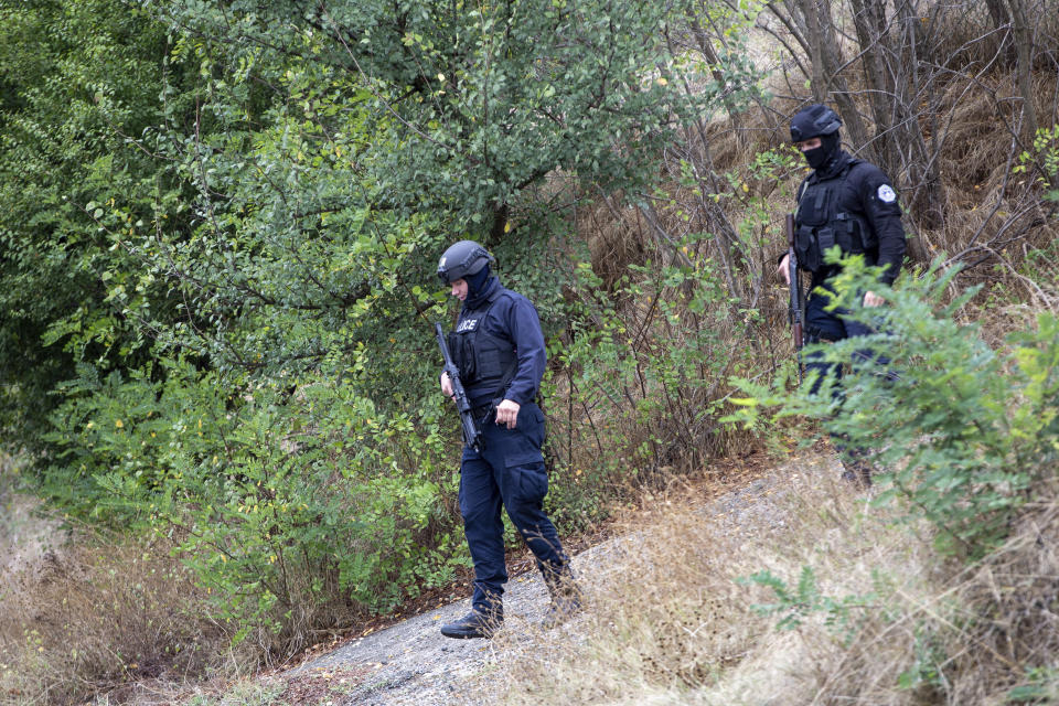 Kosovo police officers patrol an area near Banjska Monastery during a ongoing police operation in the village of Banjska on Monday, Sept. 25, 2023. Kosovo on Monday observed a day of mourning for the Kosovar Albanian police officer killed by Serb gunmen who then barricaded themselves in an Orthodox monastery in a siege that further raised tensions as the two wartime foes seek to normalize ties. In the north, where most of Kosovo’s ethnic Serb minority lives in four municipalities around Mitrovica, police were patrolling in search of the armed assailants after they left the monastery. (AP Photo/Visar Kryeziu)