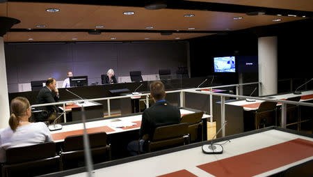 The initial remand hearing of Abderrahman Mechkah (lying in a hospital bed, attending the court session via video), 18 year-old Moroccan man suspected of killing two people and attempting to kill eight others with terrorist intent in Turku, on Friday, August 19, is held at Southwest Finland District Court in Turku, Finland, August 22, 2017. LEHTIKUVA /Martti Kainulainen via REUTERS