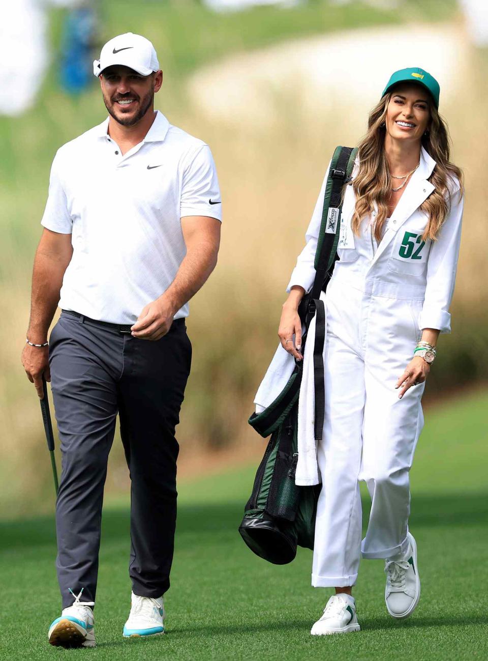 Brooks Koepka of the United States and Jena Sims during the Par Three Contest prior to the Masters at Augusta National Golf Club on April 06, 2022 in Augusta, Georgia