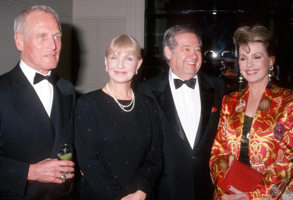 Paul Newman, Joanne Woodward, Warren Cowan and Barbara Rush smiling for the camera together.