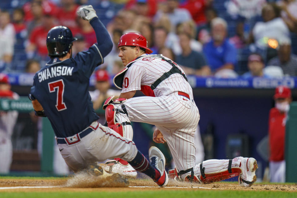 Philadelphia Phillies catcher J.T. Realmuto, right, forces out Atlanta Braves' Dansby Swanson during the second inning of a baseball game Wednesday, June 9, 2021, in Philadelphia. (AP Photo/Chris Szagola)