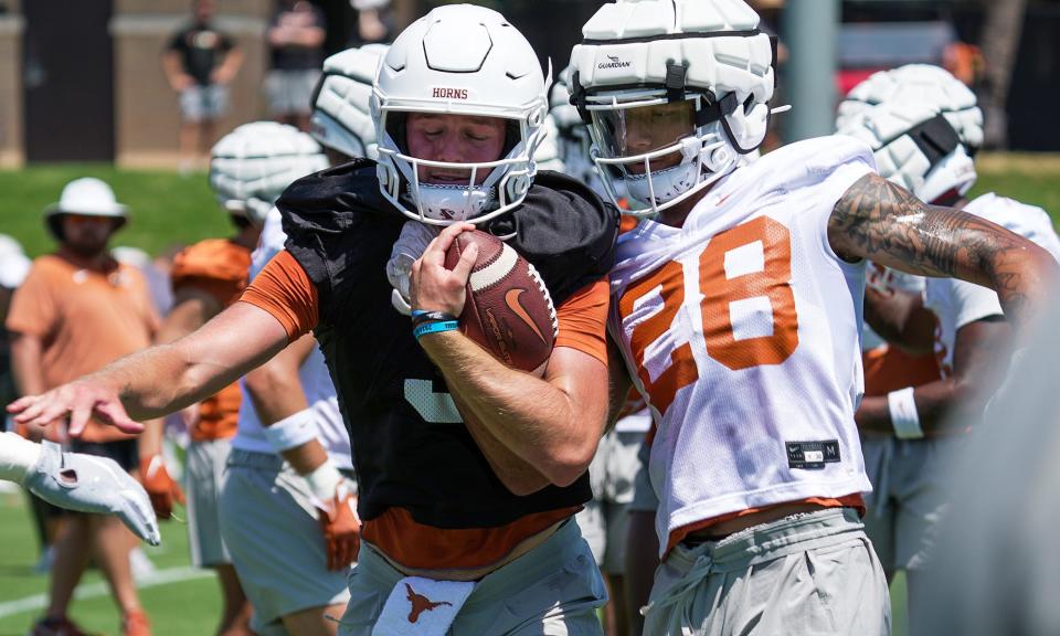 Texas quarterback Quinn Ewers holds onto the ball during the first preseason practices at the Frank Denius Fields on the University of Texas campus Wednesday. The Texas coaches praised Ewers' comfort level with the offense as he enters his second season as the starting quarterback.