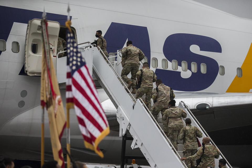 A group of soldiers with the U.S. Army's 87th Division Sustainment Support Battalion, 3rd Division Sustainment Brigade, board a chartered plane during their deployment to Europe, Friday, March 11, 2022, at Hunter Army Airfield in Savannah, Ga. The unit is attached to the Army's 3rd Infantry Division out of Fort Stewart, Ga., and will join the 3,800 troops already deployed in support of NATO in Eastern Europe. (AP Photo/Stephen B. Morton)