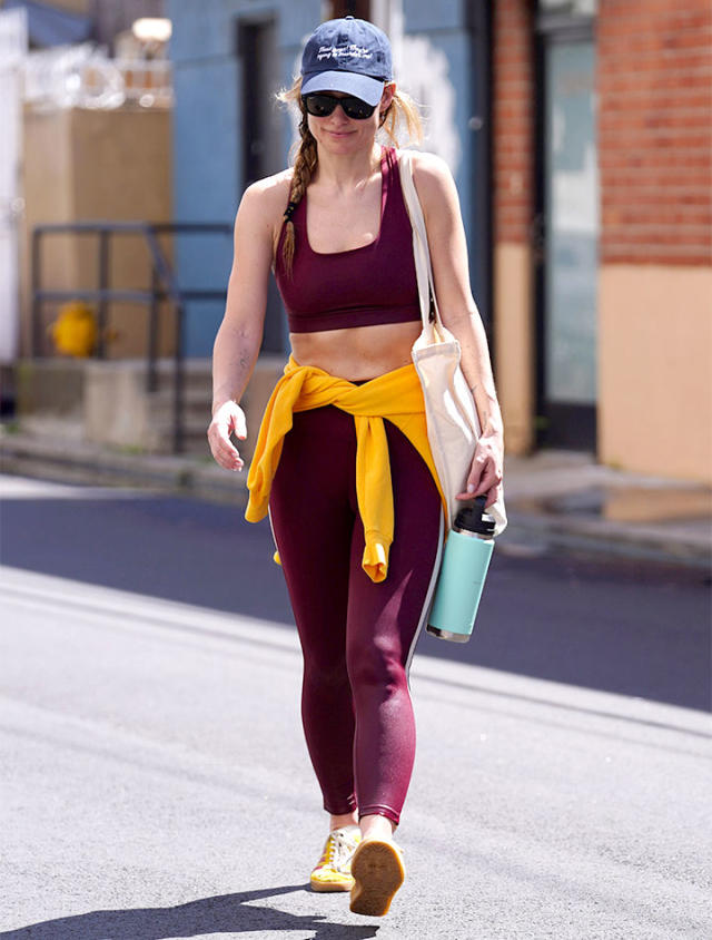 Olivia Wilde flaunts her rock hard abs in a crop top and purple leggings  while attending