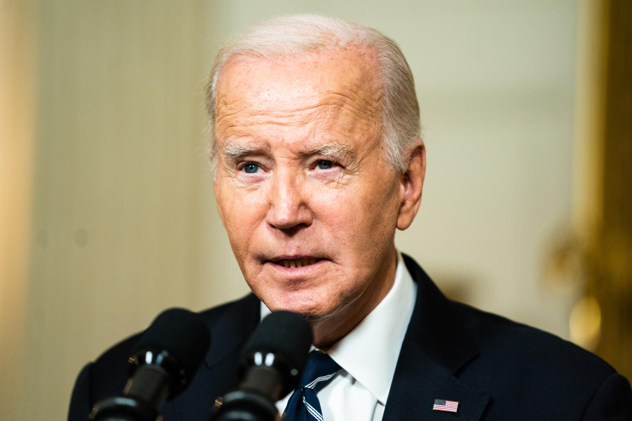 President Biden speaking into a microphone.