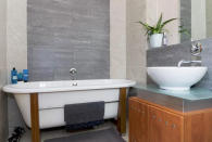 <p>The ultra-modern bathroom features a vessel sink and a soaker tub. </p>