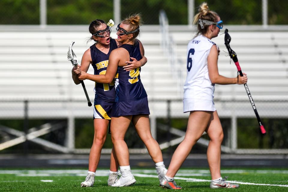 DeWitt's Elliana Hillard, right, celebrates her goal with Ireland Brown during the first half in the game against Haslett-Williamston on Friday, June 2, 2023, at DeWitt High School.