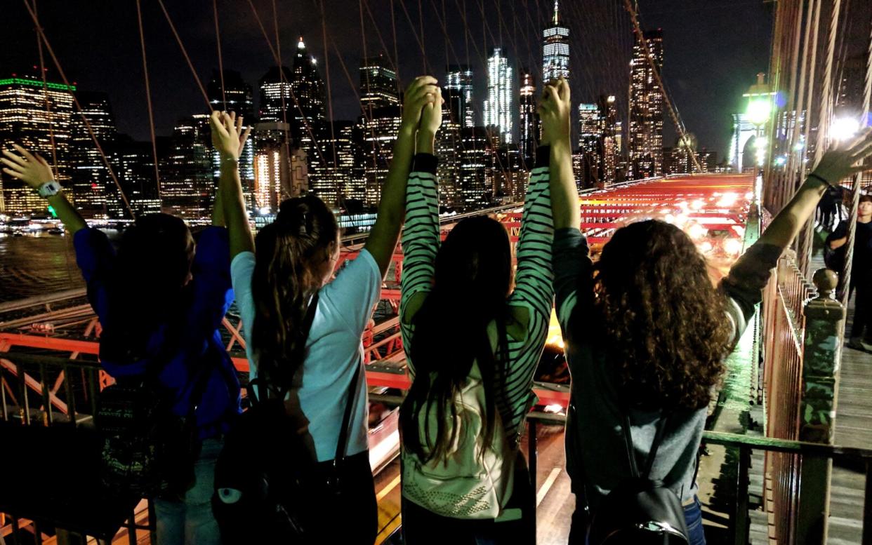 Rear View Of Friends in New York City At Night