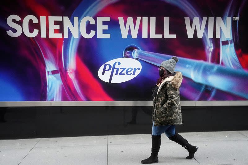 FILE PHOTO: A person walks past the Pfizer Headquarters building in New York City