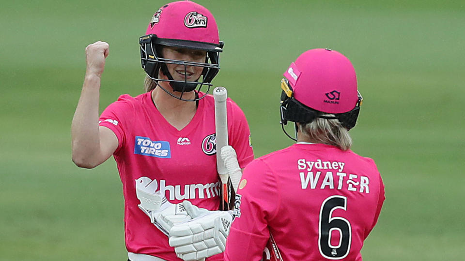 Ellyse Perry and Ashleigh Gardner of the Sixers celebrate their win over the Adelaide Strikers in the opening round of the WBBL. (Photo by Mark Metcalfe/Getty Images)