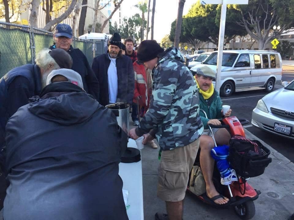 Micah's Way volunteers serve food and drink to Santa Ana, California residents, including veterans and others experiencing homelessness.