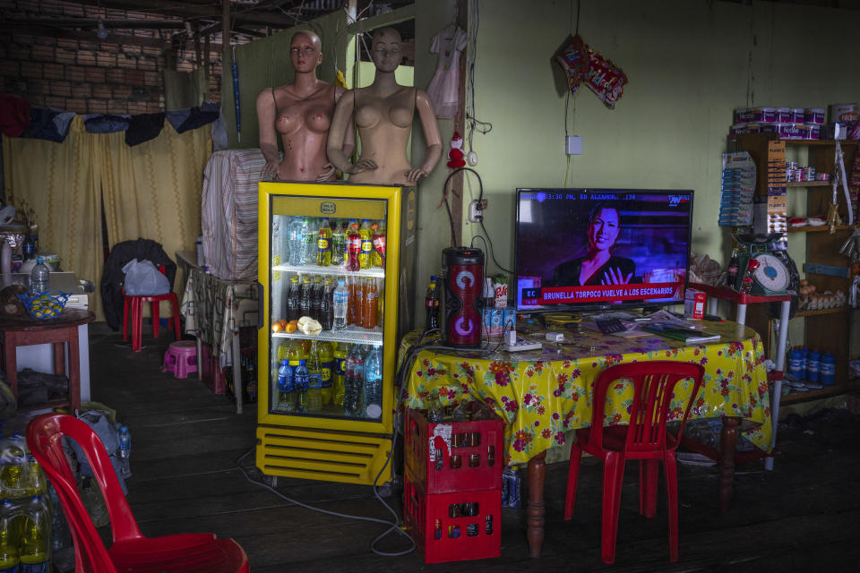 Mannequins and soft drinks are displayed for sale at a shop in the port city of Iquitos, Peru, Thursday, May 30, 2024. The federal highway project, which spans 188 kilometers (117 miles), is intended to connect Iquitos, the main city in Peru´s Amazon, with the El Estrecho district on the Colombian border. (AP Photo/Rodrigo Abd)