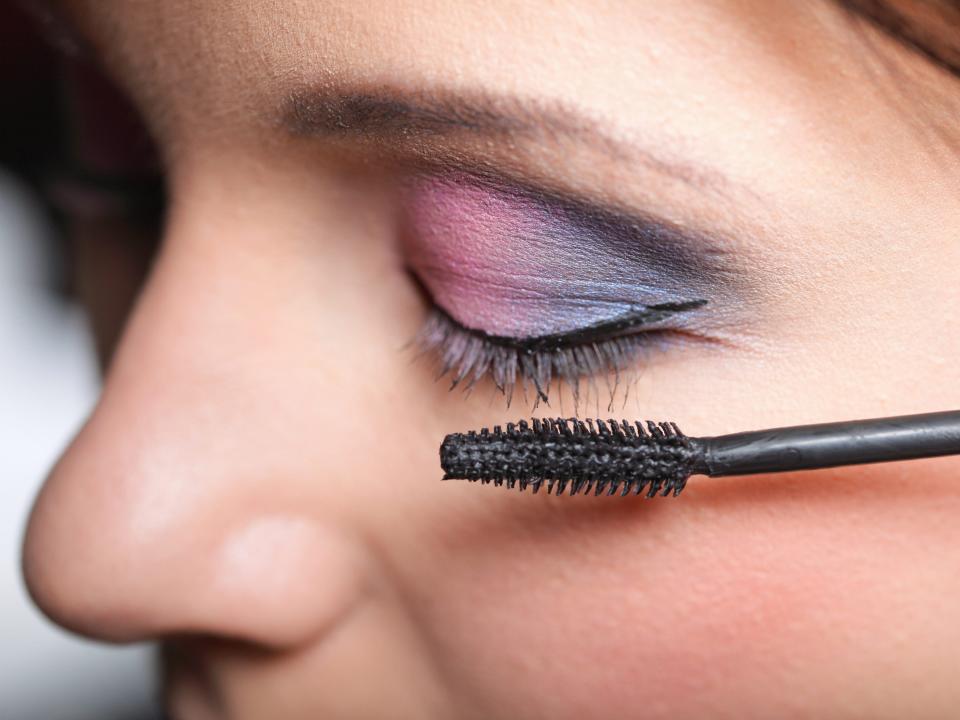 applying mascara colorful eyeshadow