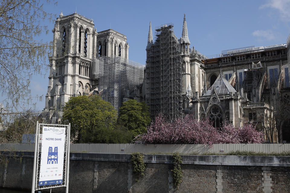 FILE - In this file photo dated Thursday, April 15, 2021, Notre Dame cathedral shrouded in scaffolding in Paris. After more than two-years of work to stabilize and protect it after the shocking fire that tore through its roof and knocked down its spire, France’s Notre Dame Cathedral is finally stable and secure enough for artisans to start rebuilding it, according to a government statement Saturday Sept. 18, 2021. (AP Photo/Francois Mori, FILE)