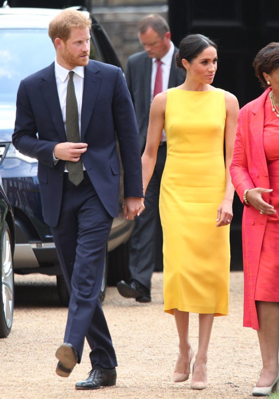 <p>The royals showed subtle PDA while attending <a href="https://www.townandcountrymag.com/style/fashion-trends/a22062433/meghan-markle-brandon-maxwell-dress-commonwealth-youth-challenge-reception/" rel="nofollow noopener" target="_blank" data-ylk="slk:the Your Commonwealth Youth Challenge reception;elm:context_link;itc:0;sec:content-canvas" class="link ">the Your Commonwealth Youth Challenge reception</a> in London on July 5. </p>