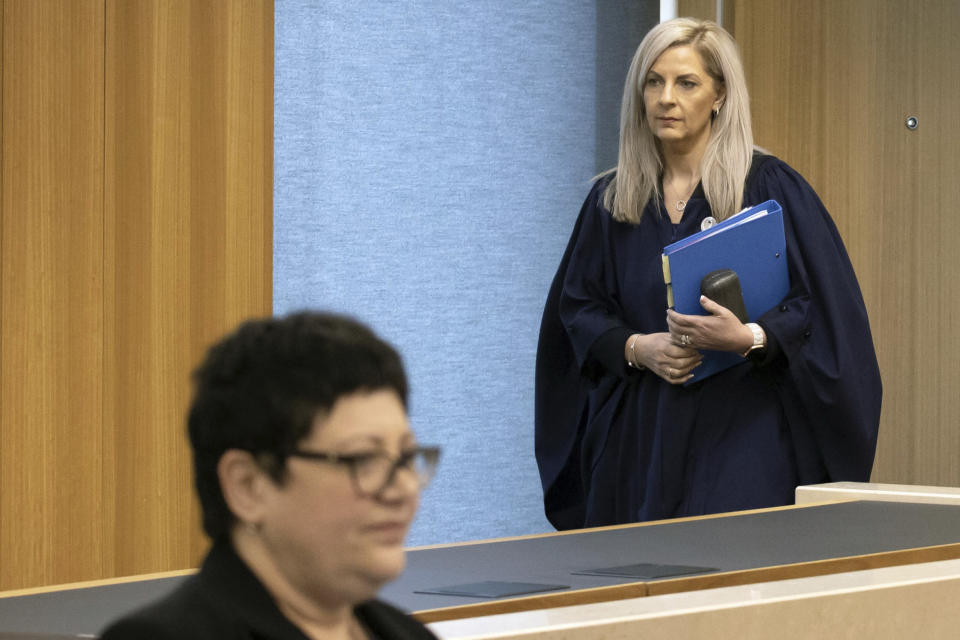 Coroner Brigitte Windley, right, enters the court for a coroner's inquiry in Christchurch, New Zealand, Tuesday, Oct. 24, 2023, into the 2019 mosque shootings. The inquiry into New Zealand’s worst mass-shooting will examine, among other issues, the response times of police and medics and whether any of the 51 people who were killed could have been saved. (Iain McGregor/Pool Photo via AP)