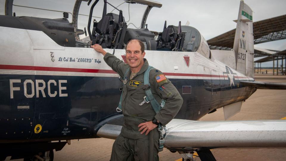Lt. Col. Robert Volpe, an instructor pilot in the 5th Flying Training Squadron, celebrates reaching 10,000 flying hours in the Air Force at Vance Air Force Base, Okla., Oct. 25, 2023. Volpe achieved this milestone while training a student pilot to fly the T-6A Texan II. (Airman 1st Class Christopher Ornelas Jr./Air Force)