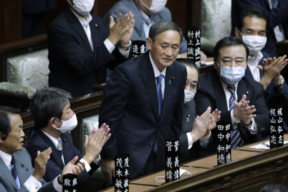 Yoshihide Suga, president of the Liberal Democratic Party (LDP), middle, receives a round of applause after being elected as Japan's prime minister during an extraordinary session at the lower house of parliament in Tokyo, Japan, on Sept. 16, 2020.<span class="copyright">Kiyoshi Ota—Bloomberg/Getty Images</span>