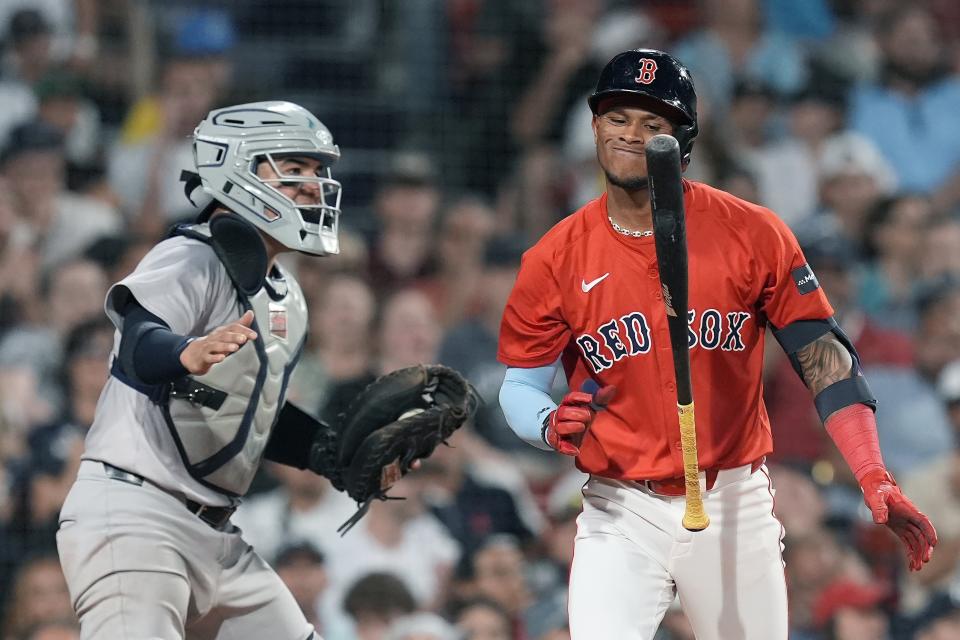 Boston Red Sox's Ceddanne Rafaela reacts in front of New York Yankees catcher Jose Trevino after striking out swinging during the fourth inning of a baseball game Friday, June 14, 2024, in Boston. (AP Photo/Michael Dwyer)