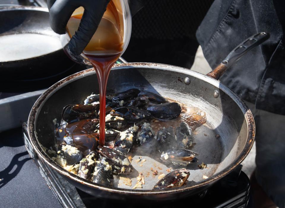 Drift executive chef Andrew Suthers prepares on order of Teriyaki Mussels at the Seafood Festival in Pensacola on Friday, Sept. 29, 2023.