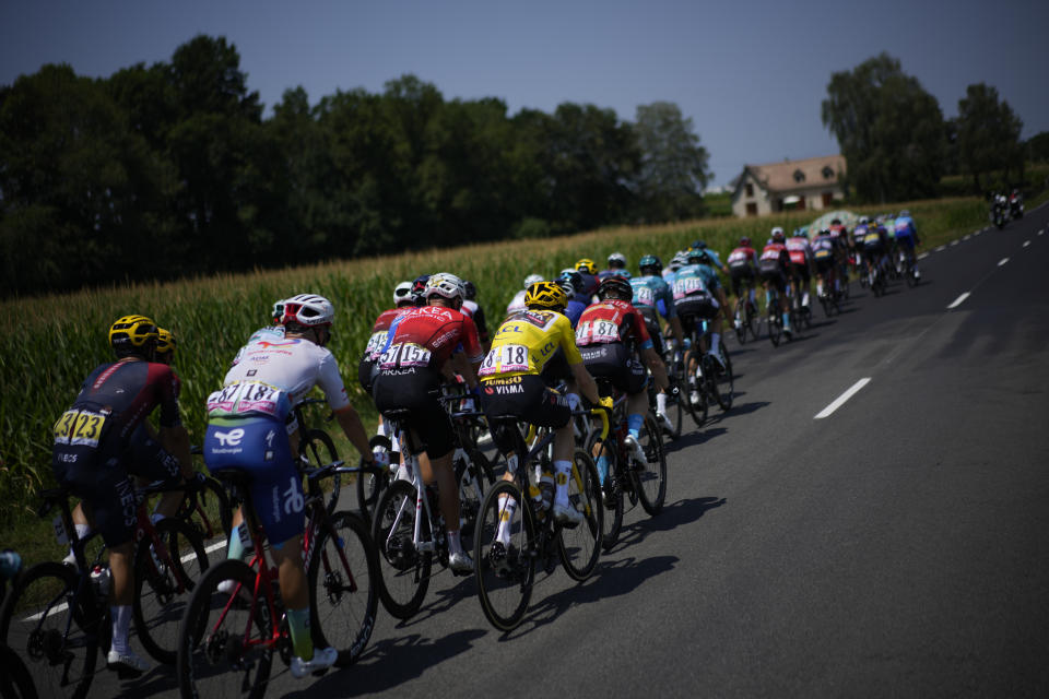 The pack with Denmark's Jonas Vingegaard, wearing the overall leader's yellow jersey, rides during the eighteenth stage of the Tour de France cycling race over 143.5 kilometers (89.2 miles) with start in Lourdes and finish in Hautacam, France, Thursday, July 21, 2022. (AP Photo/Daniel Cole)