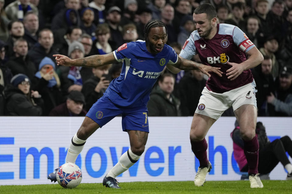 Chelsea's Raheem Sterling, left, is challenged by Aston Villa's John McGinn during the English FA Cup fourth round soccer match between Chelsea and Aston Villa at the Stamford Bridge stadium in London, Friday, Jan. 26, 2024. (AP Photo/Kin Cheung)