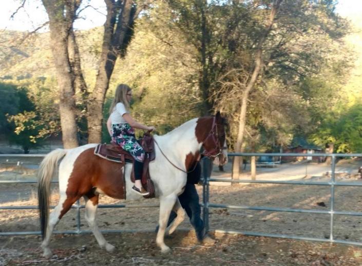 Lola Dunn, 11, riding a horse at the Rocking Lazy DJ Bar Ranch, east of Mariposa, prior to the property burning in the Oak Fire.