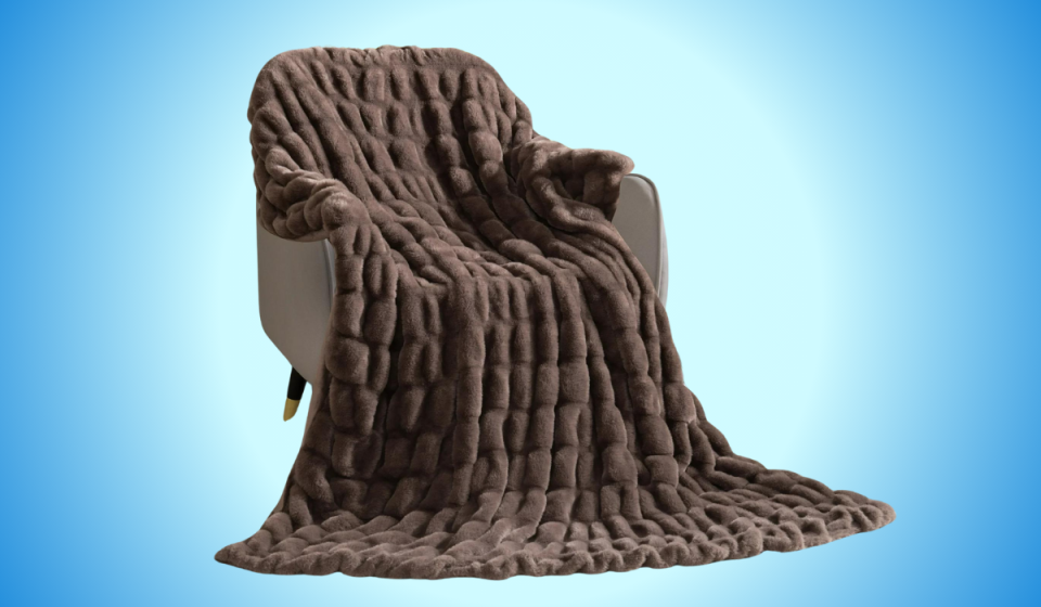 the brown throw blanket draped over an armchair