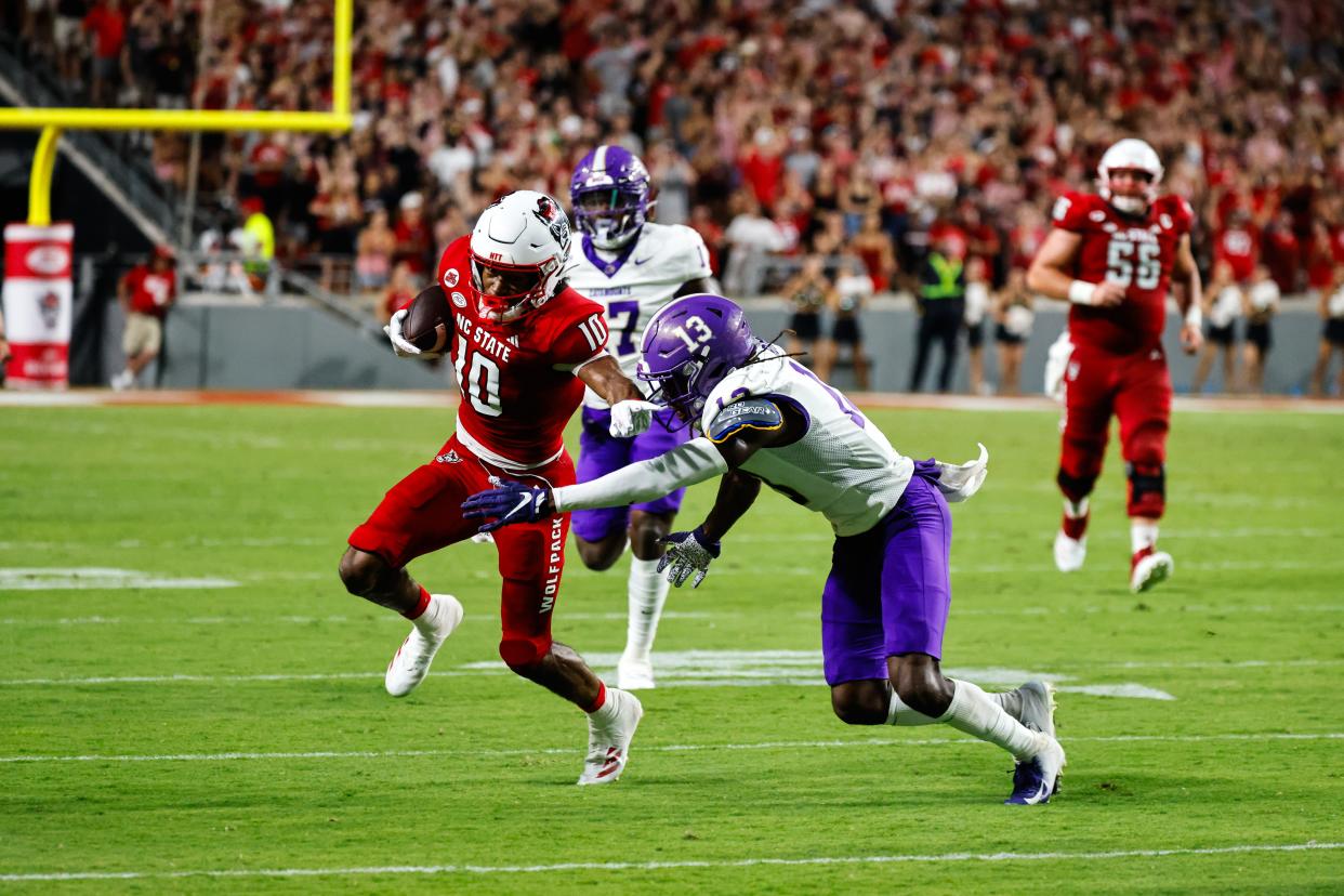 North Carolina State wide receiver Kevin Concepcion (10) runs with the ball and pushes Western Carolina defensive back Quez Royal (13) away during the first half at Carter-Finley Stadium.