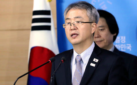 Lee Woo-sung, of the South Korean delegation, answers questions after Monday's meetings - Credit: AP