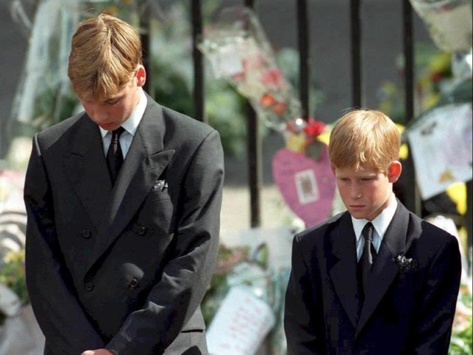 William (left) and Harry bow their heads as their mother's coffin is taken out of Westminster Abbey (AFP via Getty Images)