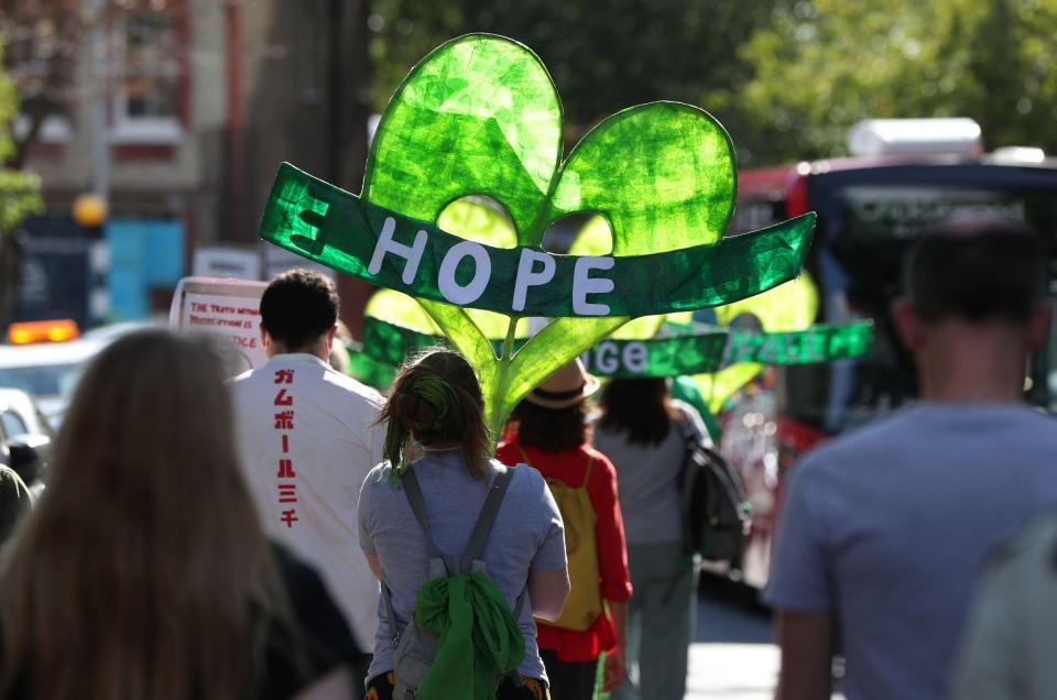 People taking part in a silent walk along Cambridge Gardens in London on the third anniversary of the Grenfell Tower fire: PA