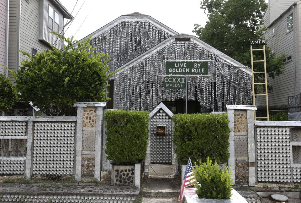 <p> The beer can house, a Houston landmark, sits between newer homes Wednesday, July 10, 2013, in Houston. Former owner John Milkovisch covered the outside on the house with siding made of cut and flatten beer cans and garlands made from the lids. The Orange Show Center for Visionary Art, a local nonprofit that preserves art installations in the city, bought the property about 10 years ago, restored the house and it opened it to the public. (AP Photo/Pat Sullivan)</p>