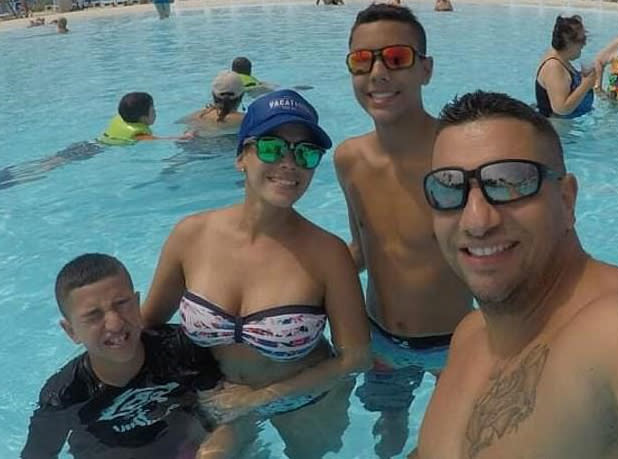 Ezequiel Almodovar, 39, Marielis Soto, 38, Ezequiel Almodovar, 16, and 12-year-old Gabriel Almodovar are all pictured in a swimming pool.