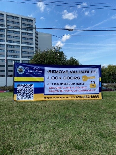 A banner posted by the Nashville police department encourages people to remove valuables from their cars and lock doors, with a QR code to learn more.