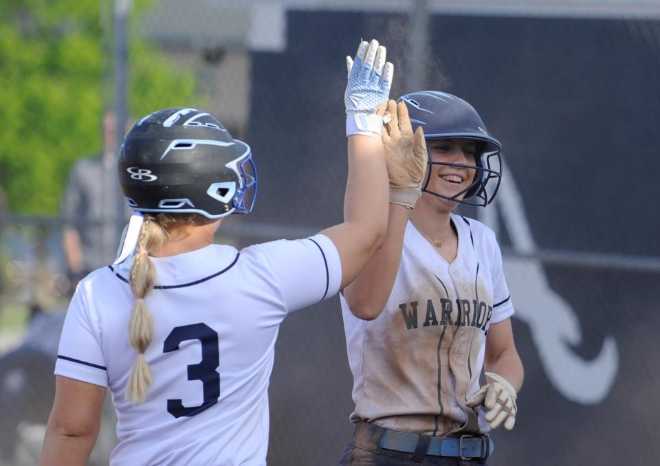 Adena's Kiera Williams (right) high-fives Caelan Miner (left) after scoring in the Warriors' 6-2 win over Unioto on May 5, 2023.