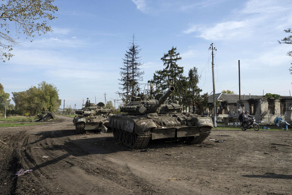 Abandoned Russian tanks stand on the road in recently liberated town Kupiansk, Ukraine, Saturday, Oct. 1, 2022. (AP Photo/Evgeniy Maloletka)