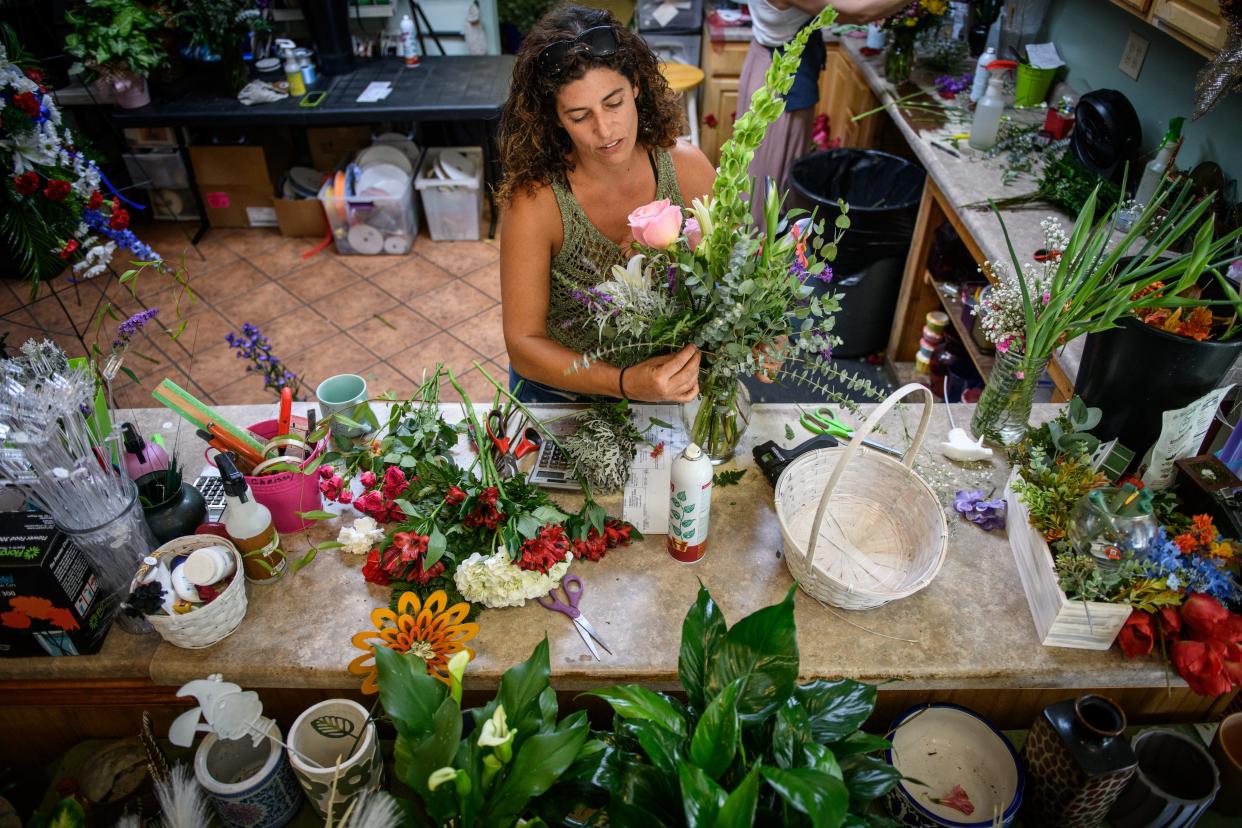 Chrissy Fair works on an arrangement at Ann's Flower Shop at 5780 Ramsey St.