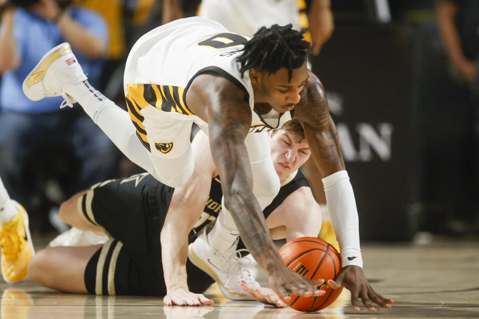 Virginia Commonwealth forward Jamir Watkins (0) dives for the ball over Vanderbilt forward Liam Robbins (21) during the first half of an NCAA college basketball game Wednesday, Nov. 30, 2022, in Richmond, Va. (Shaban Athuman/Richmond Times-Dispatch via AP)