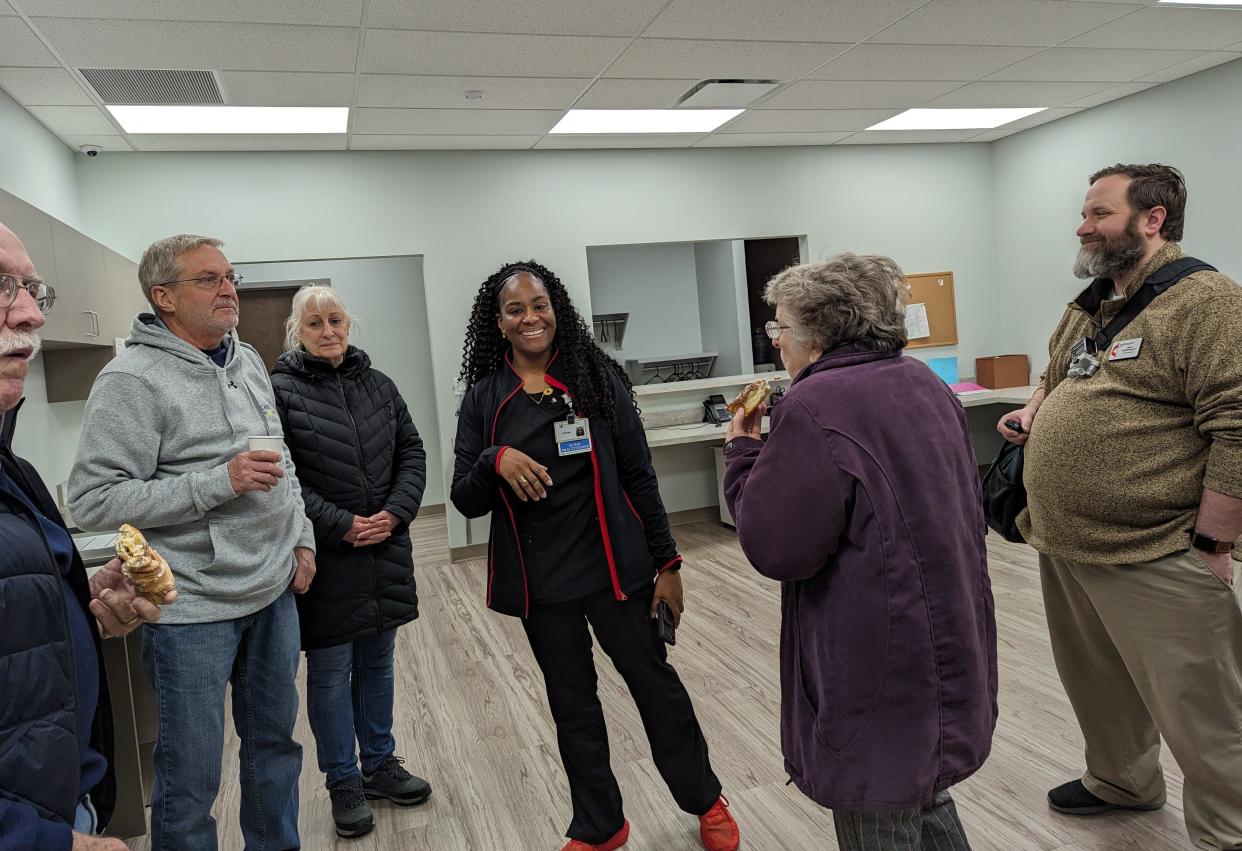 Nurse Practitioner LaToya Dickens-Jones (centers) conducts a tour at the My Community Health Center clinic located at Southeast Market Plaza in southeast Canton. The plaza, which also has a grocery store, was dedicated on Saturday.