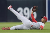 Cincinnati Reds right fielder Will Benson holds on to the ball after making a sliding catch for the out on San Diego Padres' Tyler Wade during the second inning of a baseball game, Tuesday, April 30, 2024, in San Diego. (AP Photo/Gregory Bull)