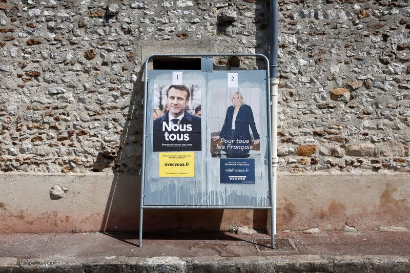 Official campaign posters of 2022 French presidential election candidates are displayed in Longnes