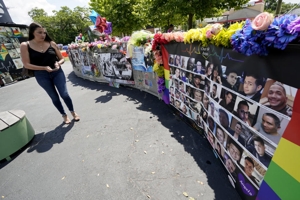 A visitor looks over a display with the photos and names of the 49 victims that died at the Pulse nightclub memorial Friday, June 11, 2021, in Orlando, Fla. / Credit: AP Photo/John Raoux