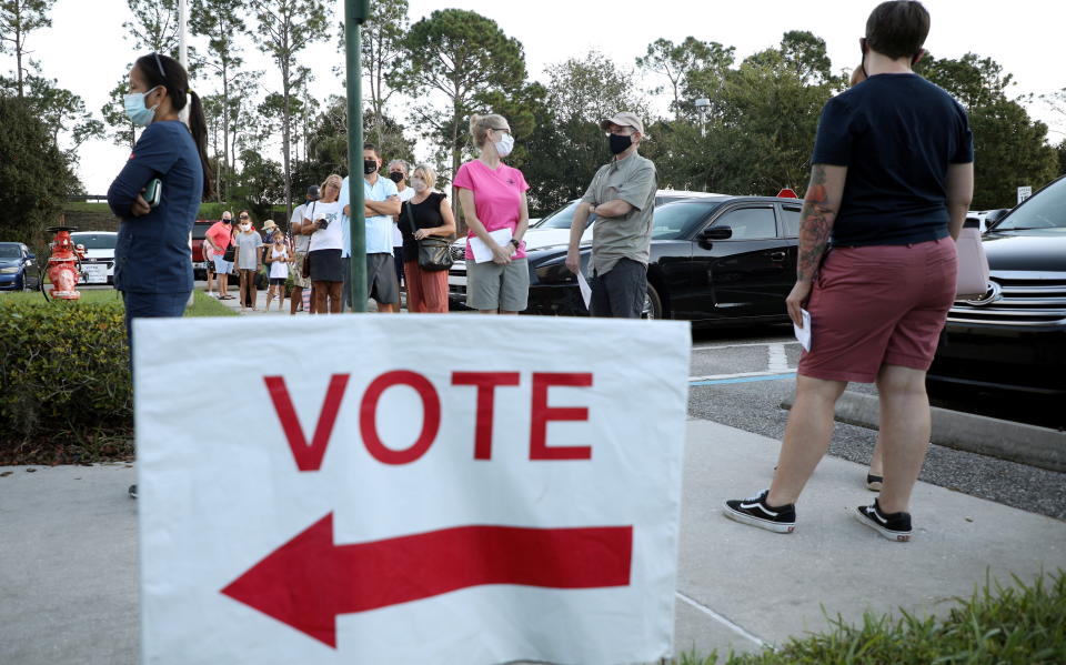 Voters line up to cast their ballots during early voting in Celebration, Florida, Oct. 25. (Photo: Gregg Newton / Reuters)