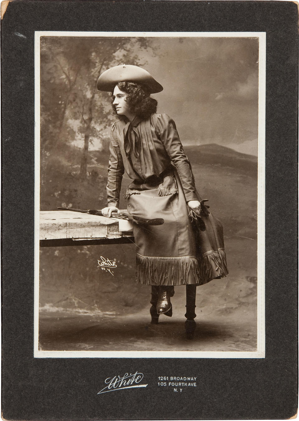 In this handout photo, provided by Heritage Auctions, Annie Oakley is seen as The Western Girl in a Cabinet Photo, signed and inscribed on verso. This is one of a series of photographs taken in 1902 or 1903 in New York. Relatives of Oakley are selling items that once belonged to the legendary sharpshooter including a Stetson hat, guns, letters and photographs. Heritage Auctions will offer up about 100 items related to Oakley on Sunday in Dallas.(AP Photo/Courtesy of Heritage Auctions)