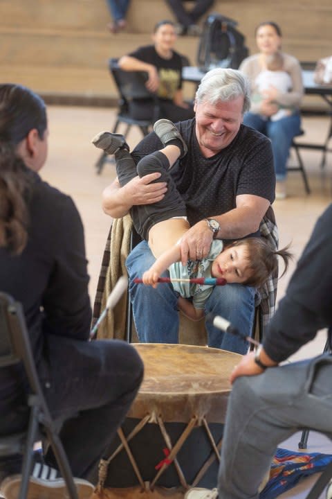 Dan Rutledge and his grandson Beau Waterman, Jr., participate in the drum circle with members of the Prairie Rose Wellbriety, a group for Native Americans in recovery, for people trying to get sober, or friends and family supporting them. (Jeff Tuttle / KMUW)